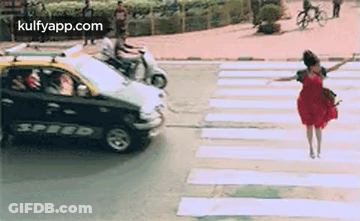 Woman In Red Dress Crossing Street GIF