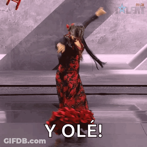 Woman In Red Dress Dancing In Front Of Yole Sign GIF