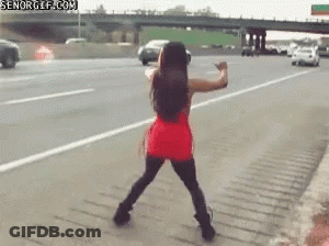 Woman In Red Dress Dancing On Highway GIF