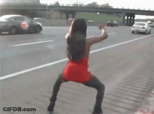 Woman In Red Dress Dancing On Highway GIF