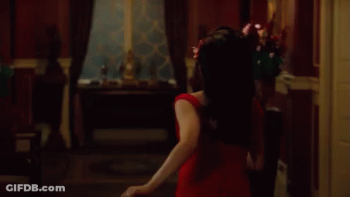 Woman In Red Dress Dancing With Falling Petals GIF