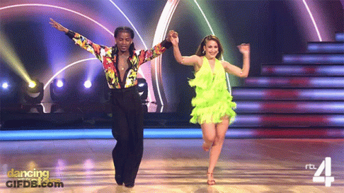 Woman In Red Dress Dancing With Man In Blue Suit GIF