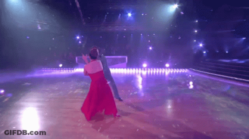 Woman In Red Dress Dancing With Man In Blue Suit GIF