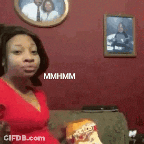 Woman In Red Dress Eating Chips On Couch GIF