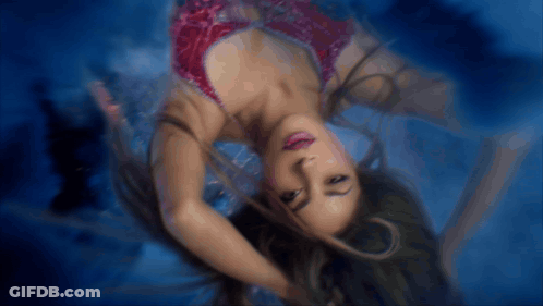 Woman In Red Dress Floating In Pool GIF