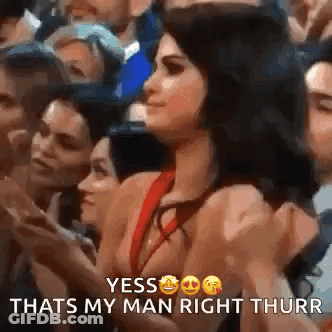 Woman In Red Dress Giving Thumbs Up In Crowd GIF