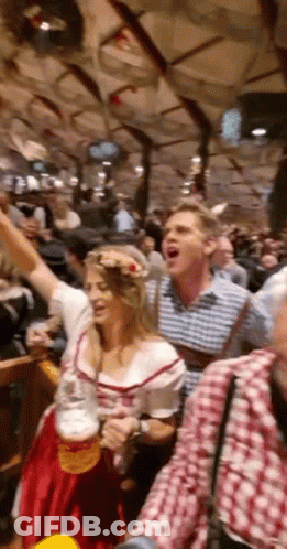 Woman In Red Dress Holding Beer While Man Shouts GIF