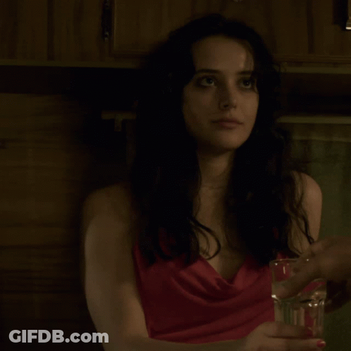Woman In Red Dress Holding Glass Of Water GIF