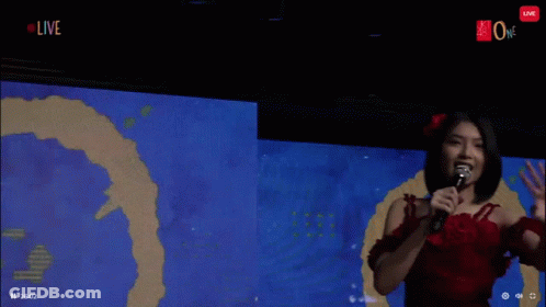 Woman In Red Dress Holding Microphone GIF
