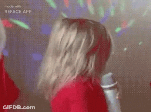 Woman In Red Dress Holding Microphone Dancing GIF