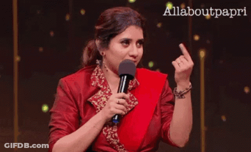Woman In Red Dress Holding Microphone Giving Middle Finger GIF