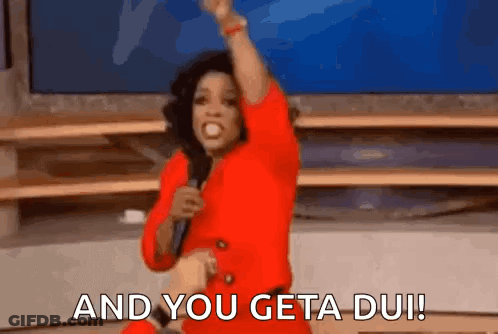 Woman In Red Dress Holding Microphone Saying And You Get A Du GIF