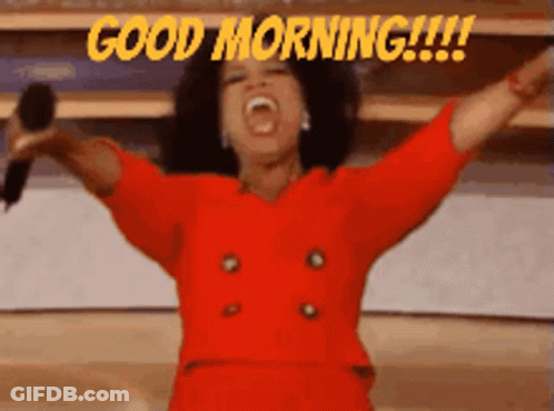 Woman In Red Dress Holding Microphone Saying Good Morning GIF