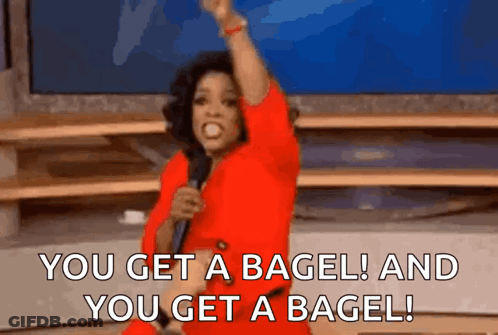 Woman In Red Dress Holding Microphone Saying You Get A Bagel GIF