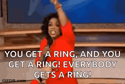 Woman In Red Dress Holding Microphone Saying You Get A Ring GIF