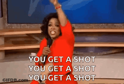 Woman In Red Dress Holding Microphone Saying You Get A Shot GIF