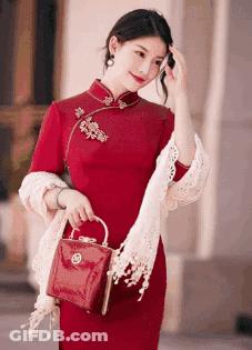 Woman In Red Dress Holding Red Bag GIF