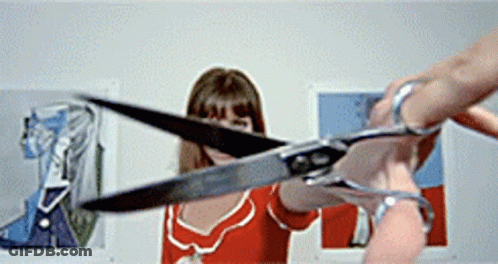 Woman In Red Dress Holding Scissors GIF