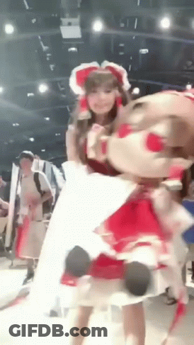Woman In Red Dress Holding Stuffed Animal GIF