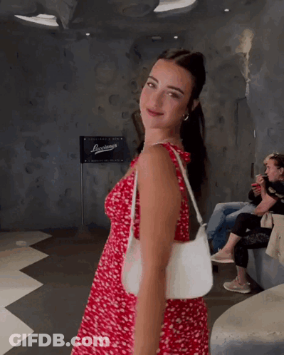 Woman In Red Dress Holding White Bag GIF