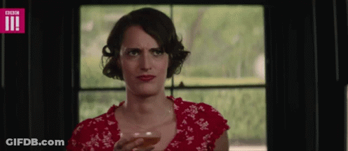 Woman In Red Dress Holding Wine And Making Face GIF