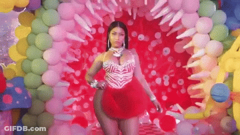Woman In Red Dress In Front Of Balloons GIF