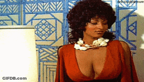 Woman In Red Dress In Front Of Blue Wall GIF