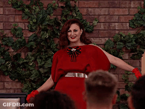 Woman In Red Dress In Front Of Crowd GIF
