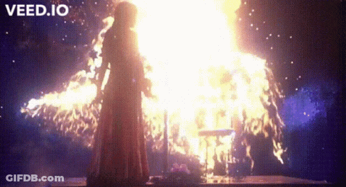 Woman In Red Dress In Front Of Fire GIF
