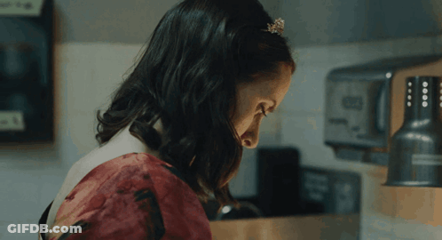Woman In Red Dress In Front Of Toaster GIF