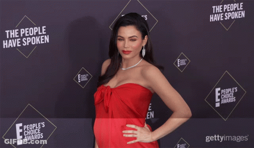 Woman In Red Dress In Front Of Wall Saying The People Have Spoken GIF