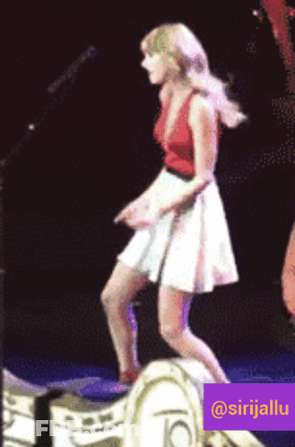 Woman In Red Dress Laughing In Front Of Screen GIF