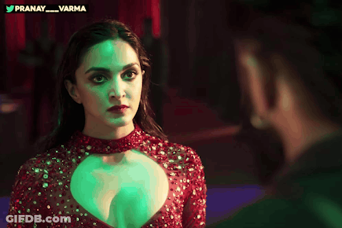 Woman In Red Dress Looking At Man In Green Light GIF