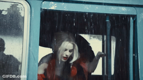 Woman In Red Dress Looking Out Window GIF