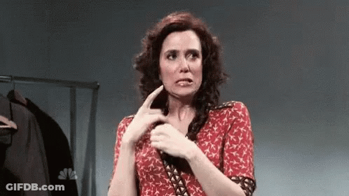 Woman In Red Dress Making Funny Face With Finger GIF