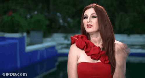 Woman In Red Dress Making Gesture GIF