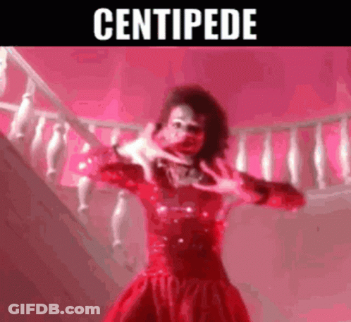 Woman In Red Dress Making Hand Gesture On Stairs GIF