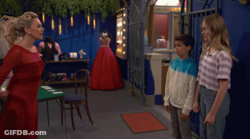 Woman In Red Dress Next To Boy In Blue And White Shirt GIF