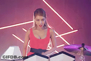 Woman In Red Dress Next To Drum Set GIF