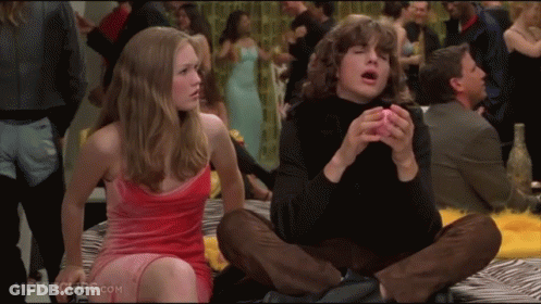 Woman In Red Dress Next To Man In Black Turtleneck Movie Scene GIF