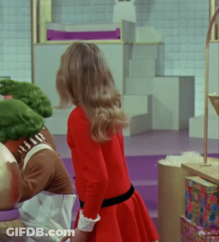 Woman In Red Dress Next To Man In Crocodile Outfit GIF