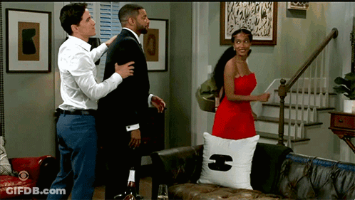 Woman In Red Dress Next To Man In Suit GIF