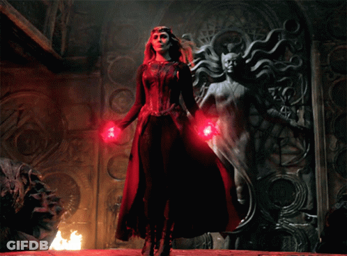 Woman In Red Dress Next To Statue GIF