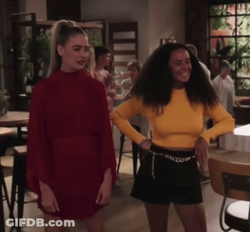 Woman In Red Dress Next To Woman In Yellow Shirt GIF