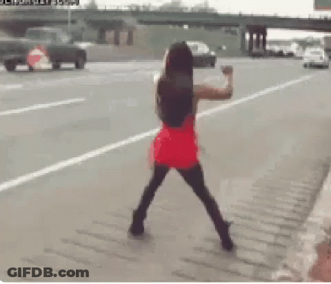 Woman In Red Dress On Roadside GIF