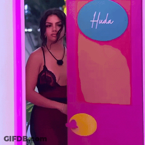 Woman In Red Dress Peeking From Pink Door GIF