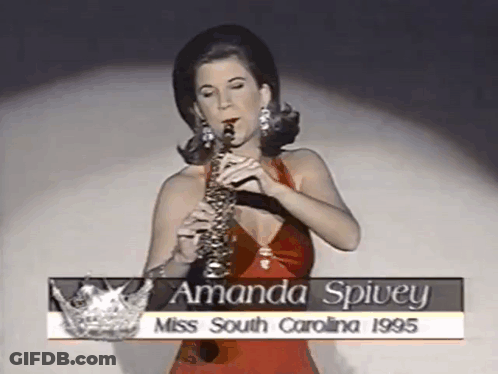 Woman In Red Dress Playing Saxophone With Miss South Carolina Crown GIF