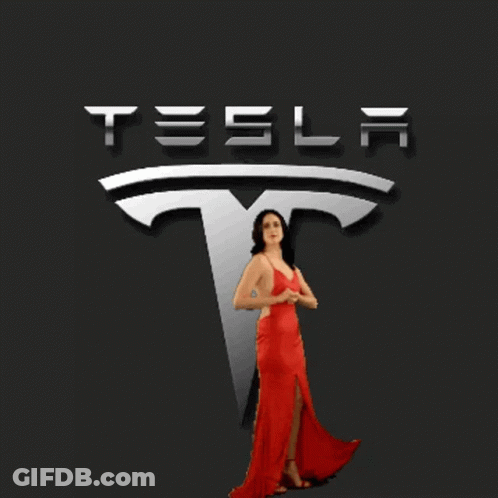 Woman In Red Dress Posing In Front Of Tesla Logo GIF