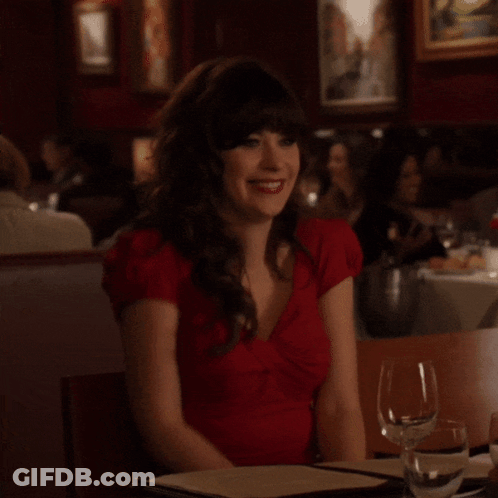 Woman In Red Dress Sitting At Table GIF