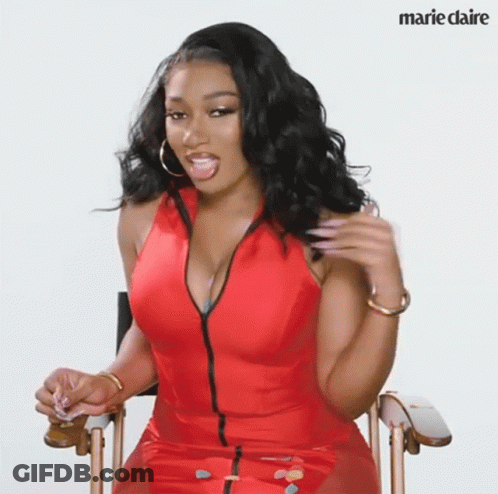 Woman In Red Dress Sitting In Chair GIF
